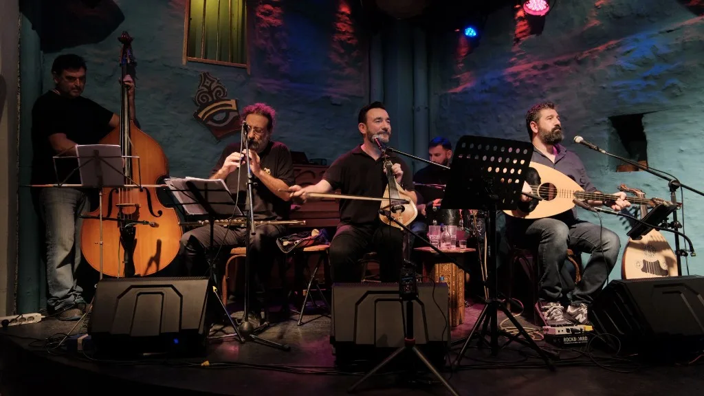 Esmiya on stage: full line-up with double bass, winds, lyra and laouto.